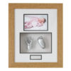Silver baby hand and foot cast in a wood frame