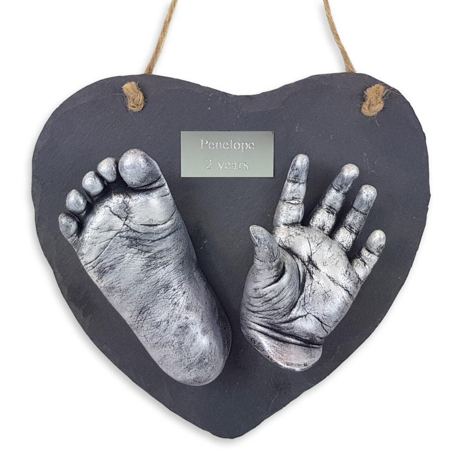 Two casts with plaque on a heart slate