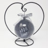 Silver hand cast in a clear bauble with heart stand