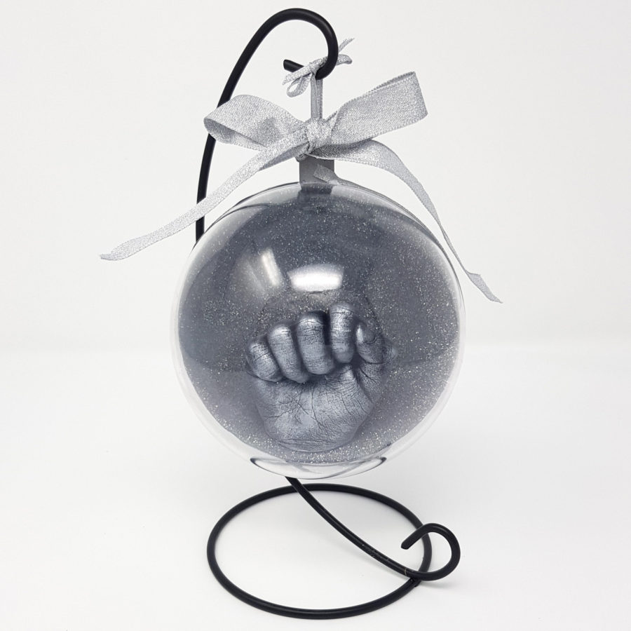 Silver hand cast in a clear bauble with stand