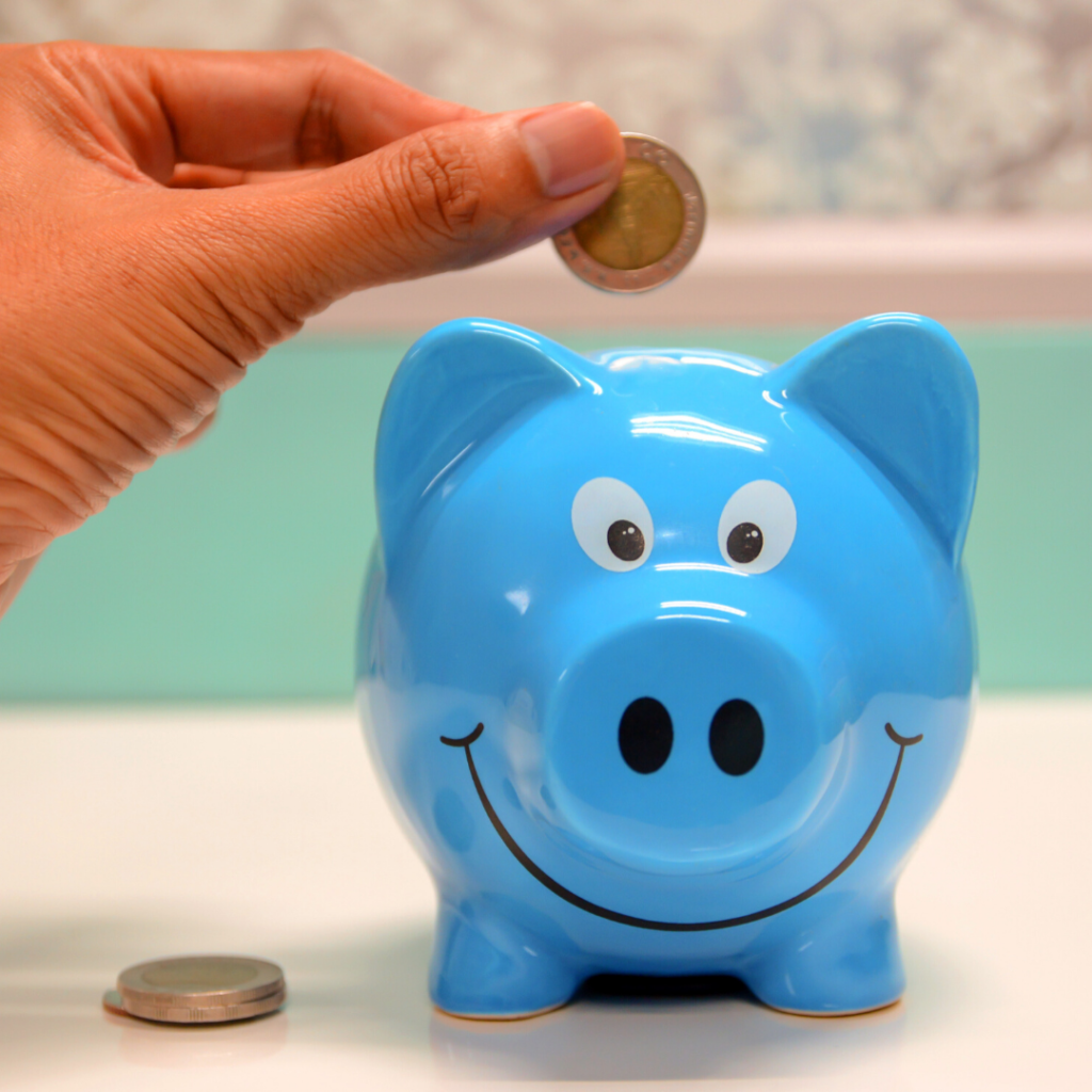 Putting money into a piggie bank