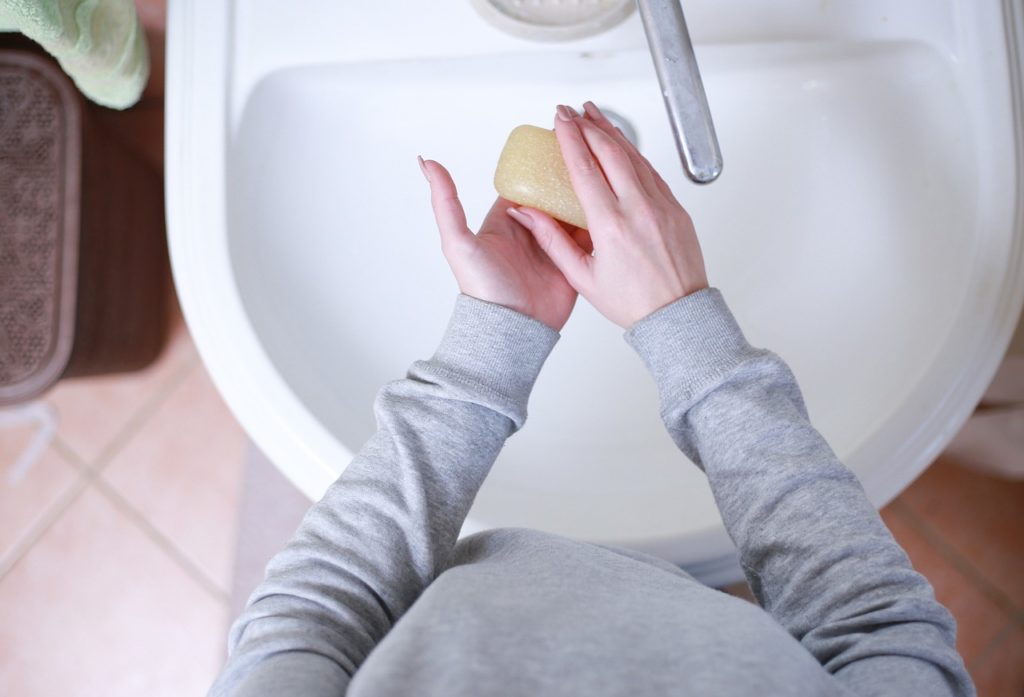 Handwashing in a sink with a bar of soap