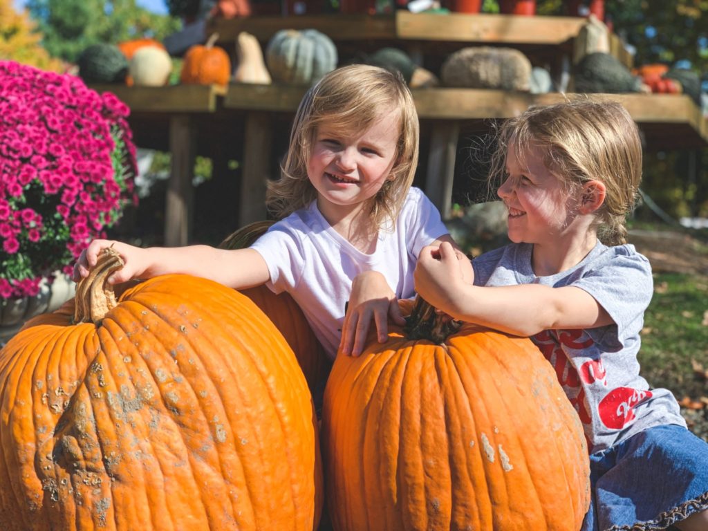 Two children with two pumpkins