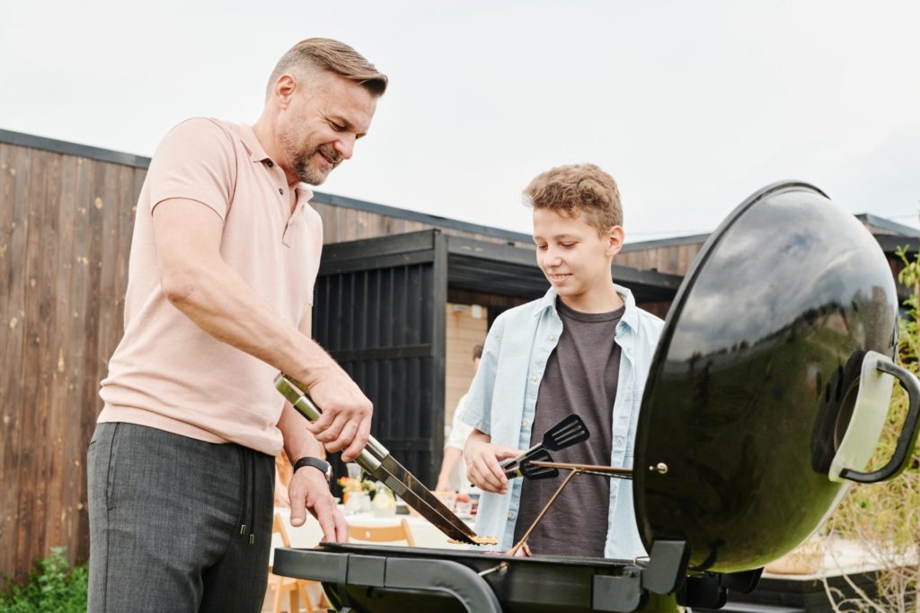 dad and son barbecuing